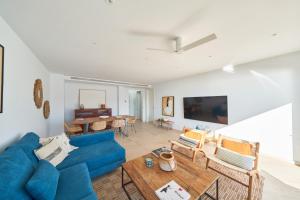 a living room with a blue couch and a table at Casa Marc in San José