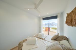 a bedroom with a large bed with a large window at Casa Marc in San José +71 photos