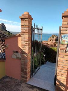 a gate to a house with a view of the ocean at Villa Olga in Nebida
