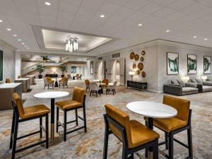 a lobby of a hotel with tables and chairs at The Fairmont Washington DC in Washington, D.C.