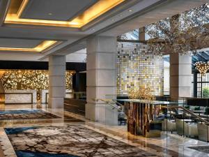 a lobby of a hotel with a chandelier at The Fairmont Washington DC in Washington