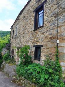 an old stone building with a window on it at Maison de charme Hautpoul in Mazamet