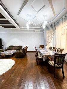 a dining room with a table and chairs at De Villa Hotel in Samarkand
