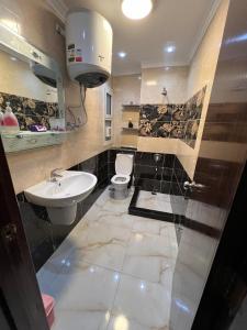 a bathroom with a sink and a toilet at Private Chalet in Porto Sokhna Pyramids in Ain Sokhna
