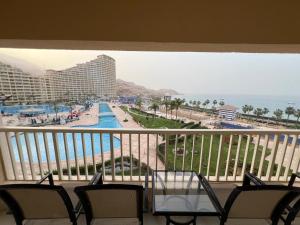 a balcony with a view of the ocean and a resort at Private Chalet in Porto Sokhna Pyramids in Ain Sokhna