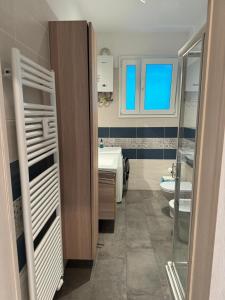 a bathroom with a sink and a toilet at La casa di Valentino in Trieste