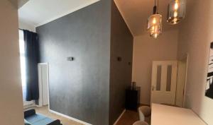 a room with a gray wall and a table and chairs at Top Wenceslas Square Apartment in Prague
