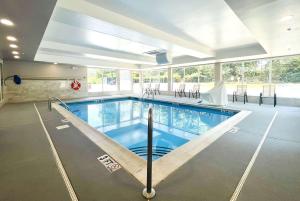 a large swimming pool in a building with a swimming pool at Wingate by Wyndham Matthews, NC in Matthews