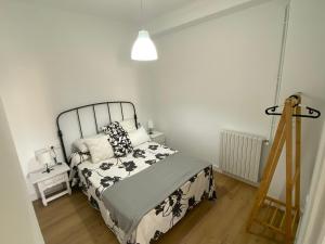 a bedroom with a bed and a lamp and a ladder at Campo de la Compañía in Monforte de Lemos