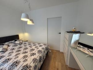 a bedroom with a bed and a dresser at Widokówka in Piła