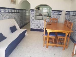 a room with a table and chairs and a bed at Casa en Punta Del Moral in Isla del Moral