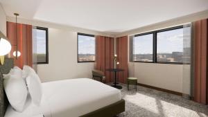 a hotel room with a white bed and windows at Doubletree By Hilton Sheffield City in Sheffield