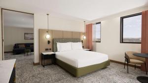 a bedroom with a bed and a living room at Doubletree By Hilton Sheffield City in Sheffield