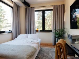 1 dormitorio con 1 cama, escritorio y ventanas en Stereo House by Larsen, en Tallin