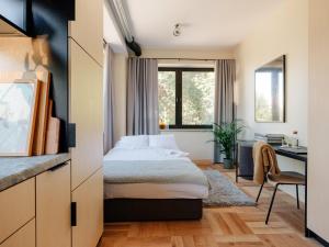 a hotel room with a bed and a desk at Stereo House by Larsen in Tallinn