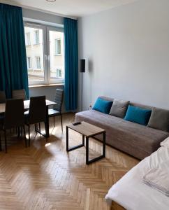 a living room with a couch and a table at Apartament III Aleja NMP in Częstochowa