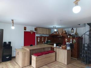 a kitchen with wooden cabinets and a counter top at Cabana Cerbului in Piatra Neamţ