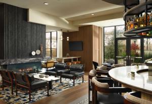 a living room with a fireplace and leather furniture at Hotel Centro Sonoma Wine Country, Tapestry Collection Hilton in Rohnert Park