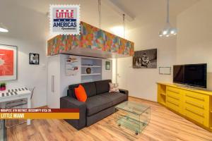 a living room with a couch and a flat screen tv at Little Americas Opera Apts in Budapest