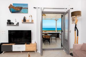 a living room with a view of the ocean at Gabriel House in Monolithos