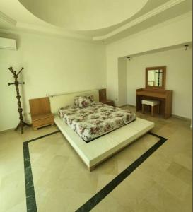 een slaapkamer met een bed en een kruis op de vloer bij Villa à yasmine hammamet in Nabeul