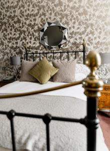 a bedroom with a bed with a mirror on the wall at Sweeney Hall Hotel in Oswestry