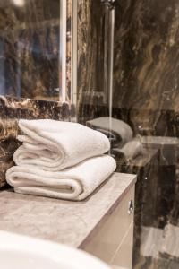 a pile of towels sitting on top of a bathroom counter at Sweeney Hall Hotel in Oswestry