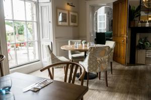 a dining room with a table and chairs at Sweeney Hall Hotel in Oswestry
