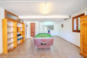 a room with a pool table on a tiled floor at Villa Pons in Playa de Muro