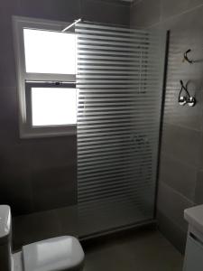 a bathroom with a shower with a window and a toilet at شاليه في امواج amwaj in El Alamein