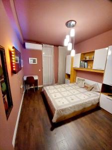 a bedroom with a large bed in a room at Аpartment Van Gogh in Hisarya