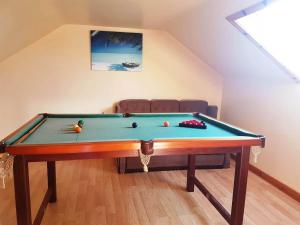 a pool table in a living room with at Pooreen House in Inverin