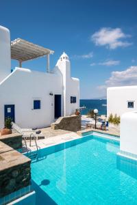 a villa with a swimming pool in front of a house at Supreme Mykonos Town House with Views & Pool & Parking in Mýkonos City