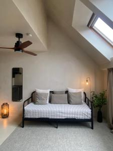 a couch in a living room with a ceiling at Edville Studio in Ghent