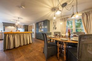 a kitchen and dining room with a table and chairs at The Gate House D in Docking