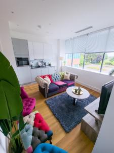 a living room with a couch and a table at Captivating 1-Bed Apartment in Slough with Kingbed in Slough