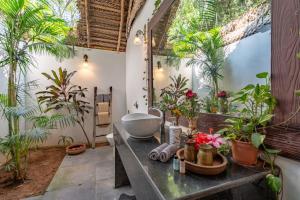 a bathroom with a sink and some plants at The Bay Agonda in Agonda