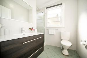 a bathroom with a toilet and a sink and a window at Piper Belle in Tamworth +8 photos