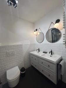 a bathroom with a sink and a toilet and a mirror at Sunny Days in Nice +10 photos