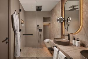 a bathroom with a sink and a shower at Lokalist, Istanbul, a Tribute Portfolio Hotel in Istanbul