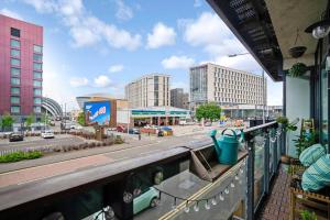 a view of a city from a balcony at Luxury Huge Modern Open Plan 2Bedroom Flat - Free Private Parking & Balcony located at the OVO Hydro and SEC Centre in Glasgow