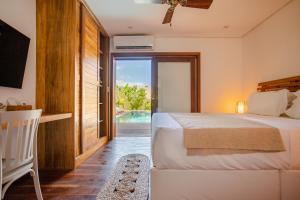 a bedroom with a bed and a view of a pool at Aldeia Jericoacoara - Suites Privativas in Jericoacoara