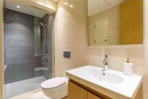 a bathroom with a sink and a shower and a toilet at Luxurious Saifi 477, 2-BR Apt in Beirut +24 photos