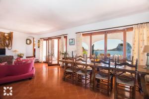 a living room with a dining room table and chairs at Villa Timeris by Abahana Villas in Calpe