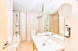 a bathroom with a sink and a mirror at Leonardo Royal Hotel Ibiza Santa Eulalia in Es Cana