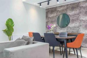 a living room with a couch and a table with chairs at Luxurious Saifi 477, 2-BR Apt in Beirut