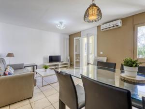 a living room with a glass table and chairs at Apartment Muga-2 by Interhome in Empuriabrava