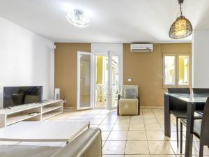 a living room with a television and a table at Apartment Muga-2 by Interhome in Empuriabrava