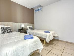 a room with two beds and a table with a lamp at Apartment Muga-2 by Interhome in Empuriabrava