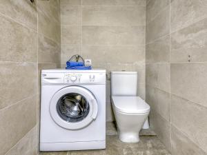 a bathroom with a washing machine and a toilet at Apartment Muga-2 by Interhome in Empuriabrava